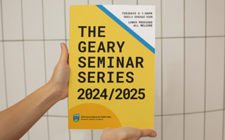 Hands holding a yellow poster that says 'The Geary Seminar Series 2024/2025'